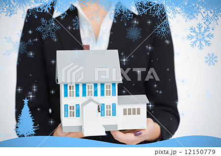 Real estate agent holding a model house 12150779