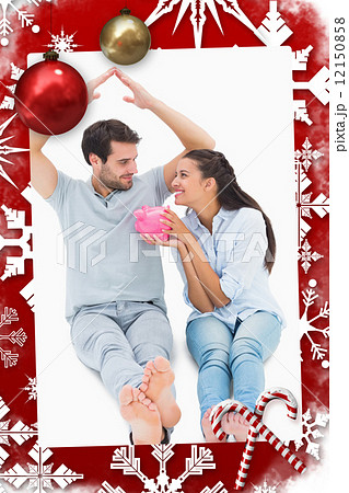 Composite image of cute couple considering a mortgage Composite image of cute couple considering a mortgage 12150858