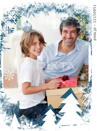 Smiling father and his son opening christmas presents Smiling father and his son opening christmas presents 12150951