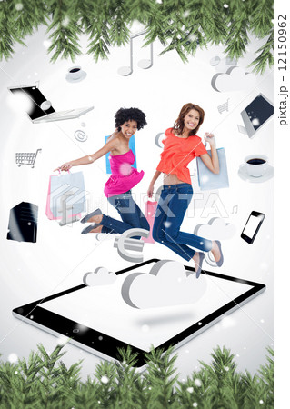 Composite image of two smiling women jumping on a tablet pc Composite image of two smiling women jumping on a tablet pc 12150962