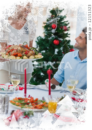 Cheerful woman bringing a roast chicken at table 12151323