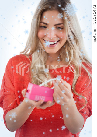 Composite image of blonde woman discovering necklace in a gift box 12151472