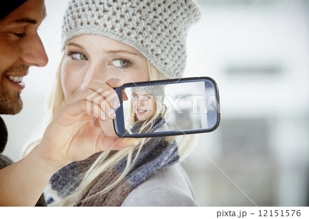 Composite image of hand holding smartphone showing Composite image of hand holding smartphone showing 12151576