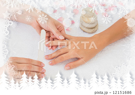 Nail technician filing customers nails Nail technician filing customers nails 12151686