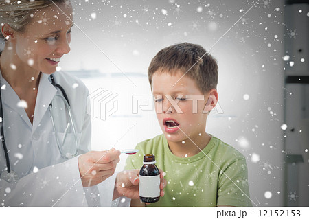 Doctor giving little boy cough syrup 12152153