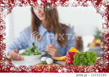 Composite image of pretty woman eating a vegetarian salad 12152194