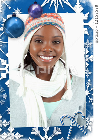 Composite image of smiling young woman in winter clothes 12152539