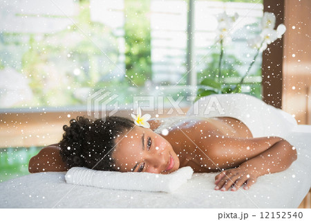Gorgeous woman lying on massage table with salt treatment on back 12152540