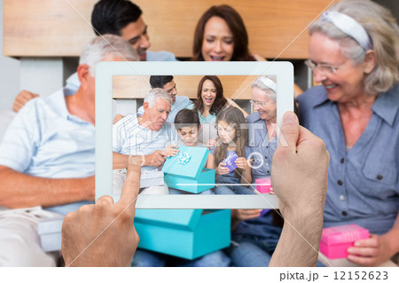 Composite image of hand holding tablet pc 12152623