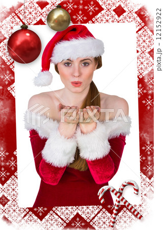 Pretty girl in santa costume blowing at camera Pretty girl in santa costume blowing at camera 12152922