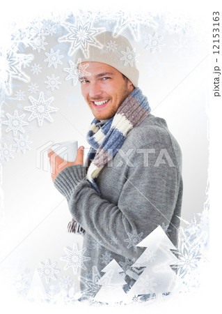 Composite image of handsome man in winter fashion holding mug Composite image of handsome man in winter fashion holding mug 12153163