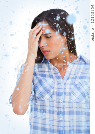 Composite image of woman with a headache and hand on forehead Composite image of woman with a headache and hand on forehead 12153254