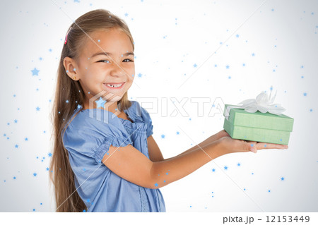 Cheerful little girl giving a present 12153449