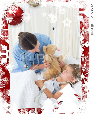 Doctor with teddy bear entertaining sick girl 12153542
