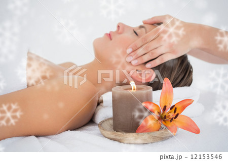Attractive woman receiving head massage at spa center Attractive woman receiving head massage at spa center 12153546
