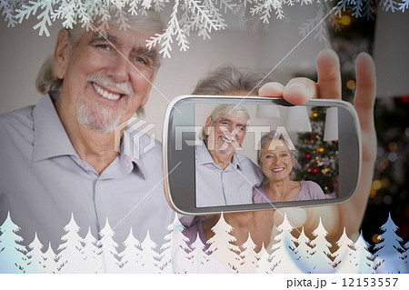 Hand holding smartphone showing photo 12153557