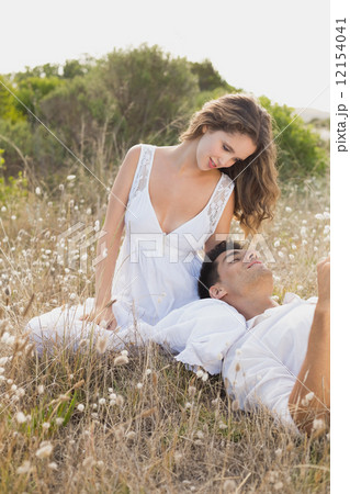 Couple sitting on countryside landscape 12154041