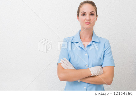 Serious dental assistant looking at camera 12154266