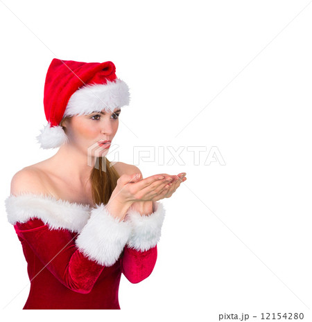 Pretty redhead in santa outfit blowing over hands 12154280