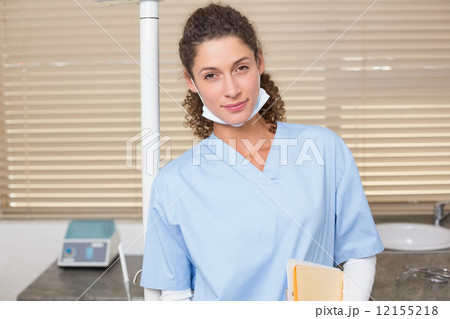 Dentist in blue scrubs looking at camera 12155218