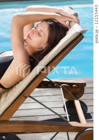 Beautiful woman in bikini relaxing by swimming pool Beautiful woman in bikini relaxing by swimming pool 12155443