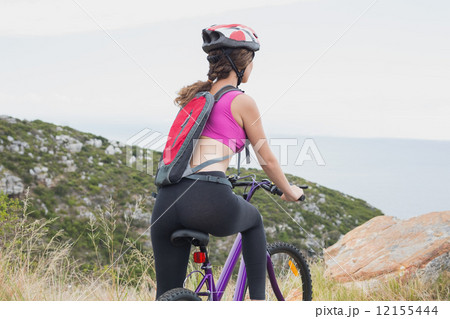 Athletic woman mountain biking 12155444