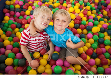 Happy children playing in ball pool Happy children playing in ball pool 12155512