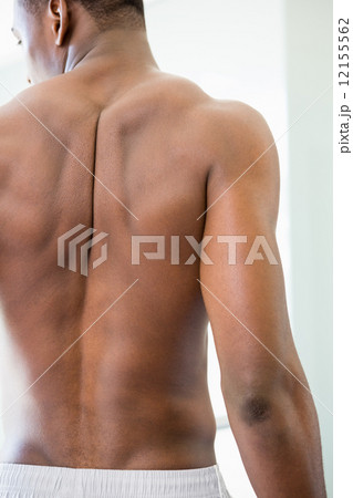 Rear view of a shirtless muscular man Rear view of a shirtless muscular man 12155562