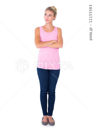 Pretty young blonde in pink thinking with arms crossed Pretty young blonde in pink thinking with arms crossed 12155563