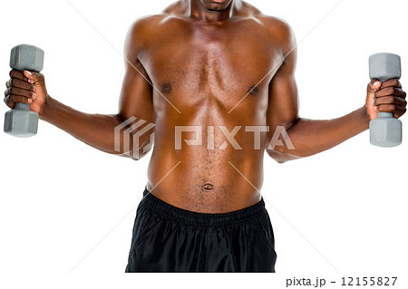 Mid section of fit shirtless man lifting dumbbells 12155827