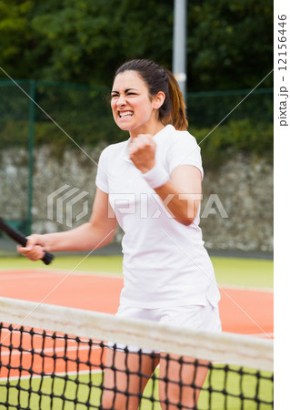 Pretty tennis player celebrating a win Pretty tennis player celebrating a win 12156446