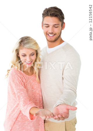 Attractive couple holding their hands out 12156542
