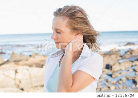 Casual woman standing by the sea 12156704