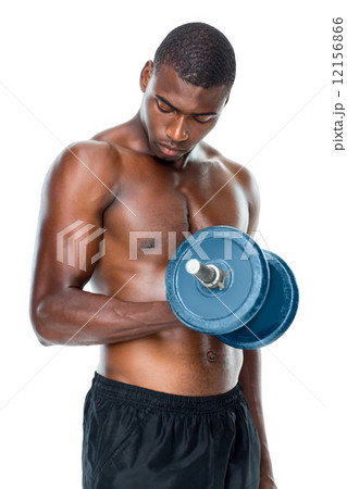 Determined fit shirtless young man lifting dumbbell 12156866