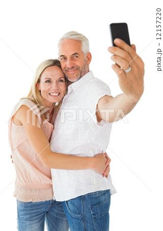Happy couple posing for a selfie 12157220
