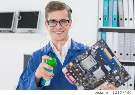 Smiling technician working on broken cpu 12157430