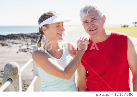 Fit mature couple warming up together on the pier 12157680