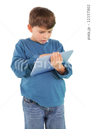Cute little boy using tablet pc Cute little boy using tablet pc 12157802