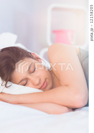 Beautiful brunette lying on bed sleeping Beautiful brunette lying on bed sleeping 12158205