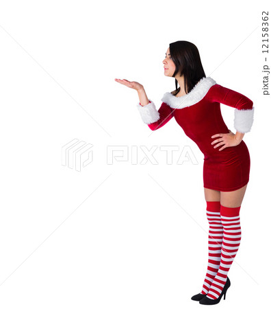 Pretty brunette in santa outfit blowing over hand Pretty brunette in santa outfit blowing over hand 12158362