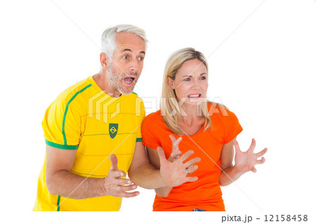 Football fan couple looking nervously ahead 12158458