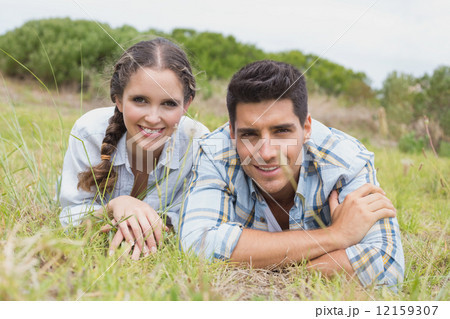 Couple lying on countryside landscape 12159307