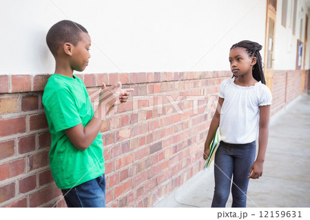 Pupil bullying another in the hall 12159631