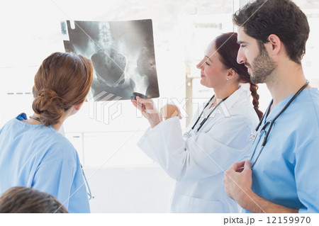 Doctor holding up an x-ray Doctor holding up an x-ray 12159970