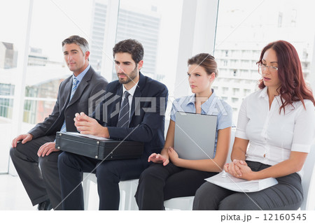 Serious business people sitting together 12160545