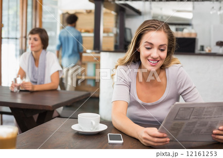 Pretty blonde reading the newspaper Pretty blonde reading the newspaper 12161253