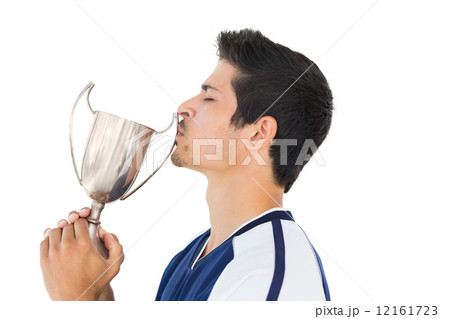 Football player kissing winners cup Football player kissing winners cup 12161723