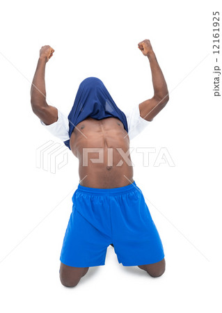 Full length of fit football player cheering 12161925