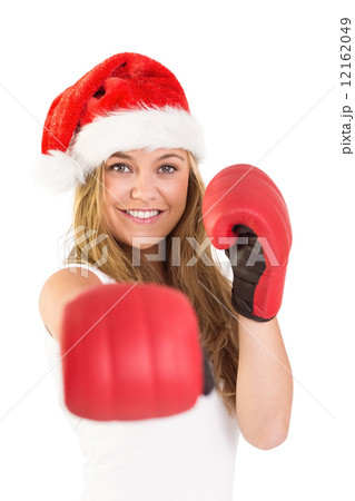 Festive blonde punching with boxing gloves Festive blonde punching with boxing gloves 12162049