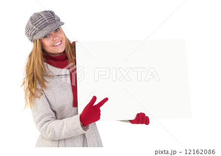 Happy blonde in winter clothes showing card Happy blonde in winter clothes showing card 12162086